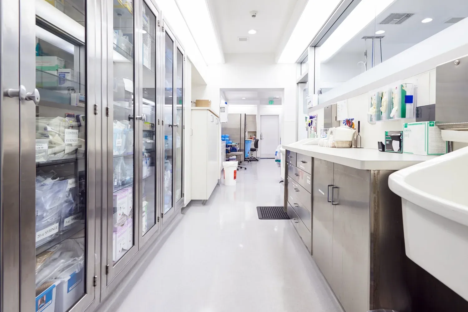 Clean hospital supply corridor with stainless steel cabinets